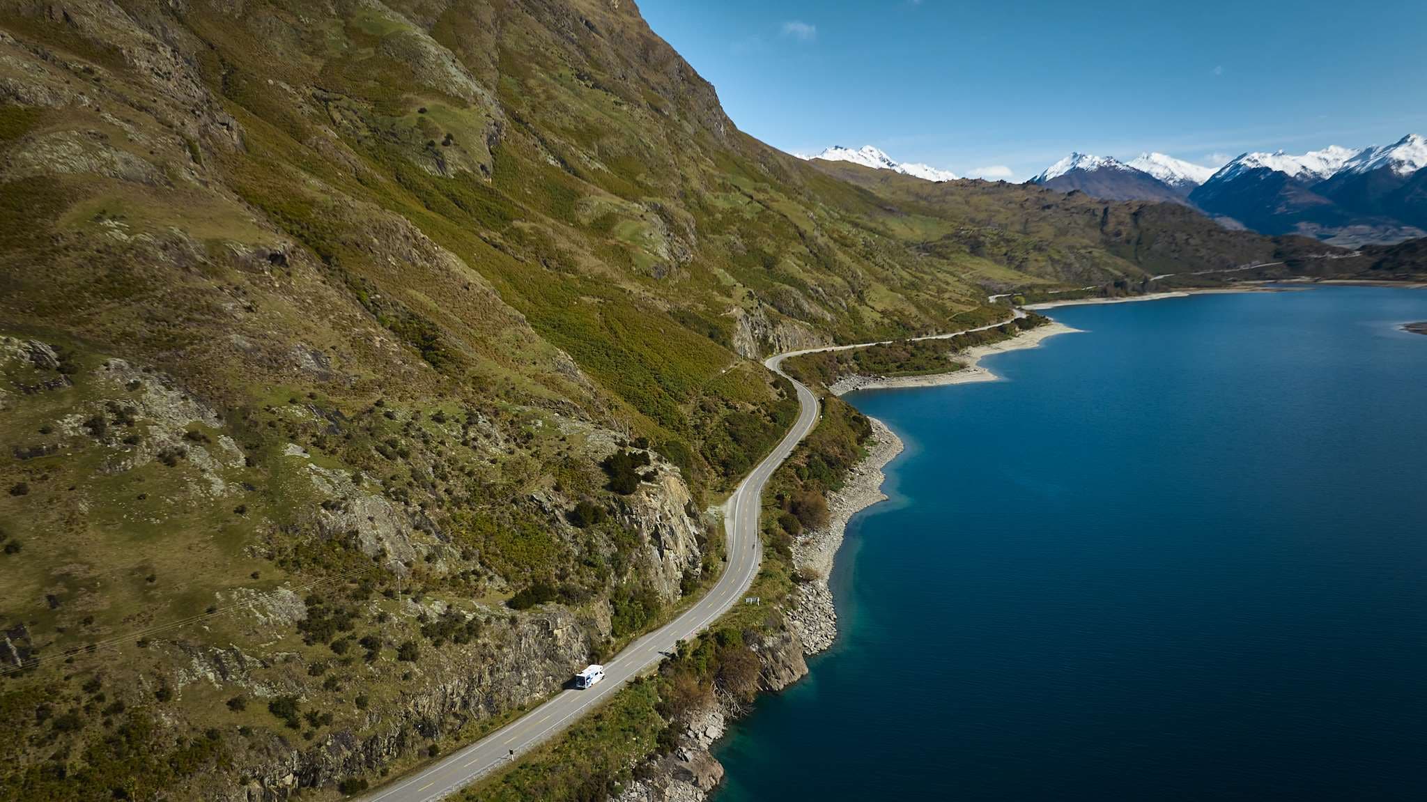 Polaris 6 motorhome dirving along scenic nz lake