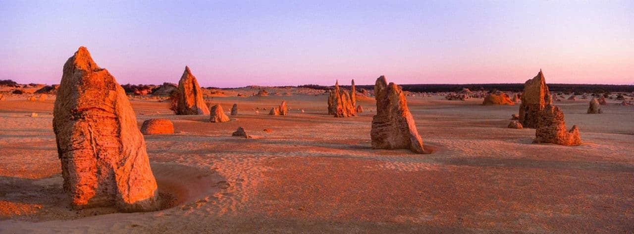 The Pinnacles Desert near Cervantes, Western Australia, glows red at sunset.
