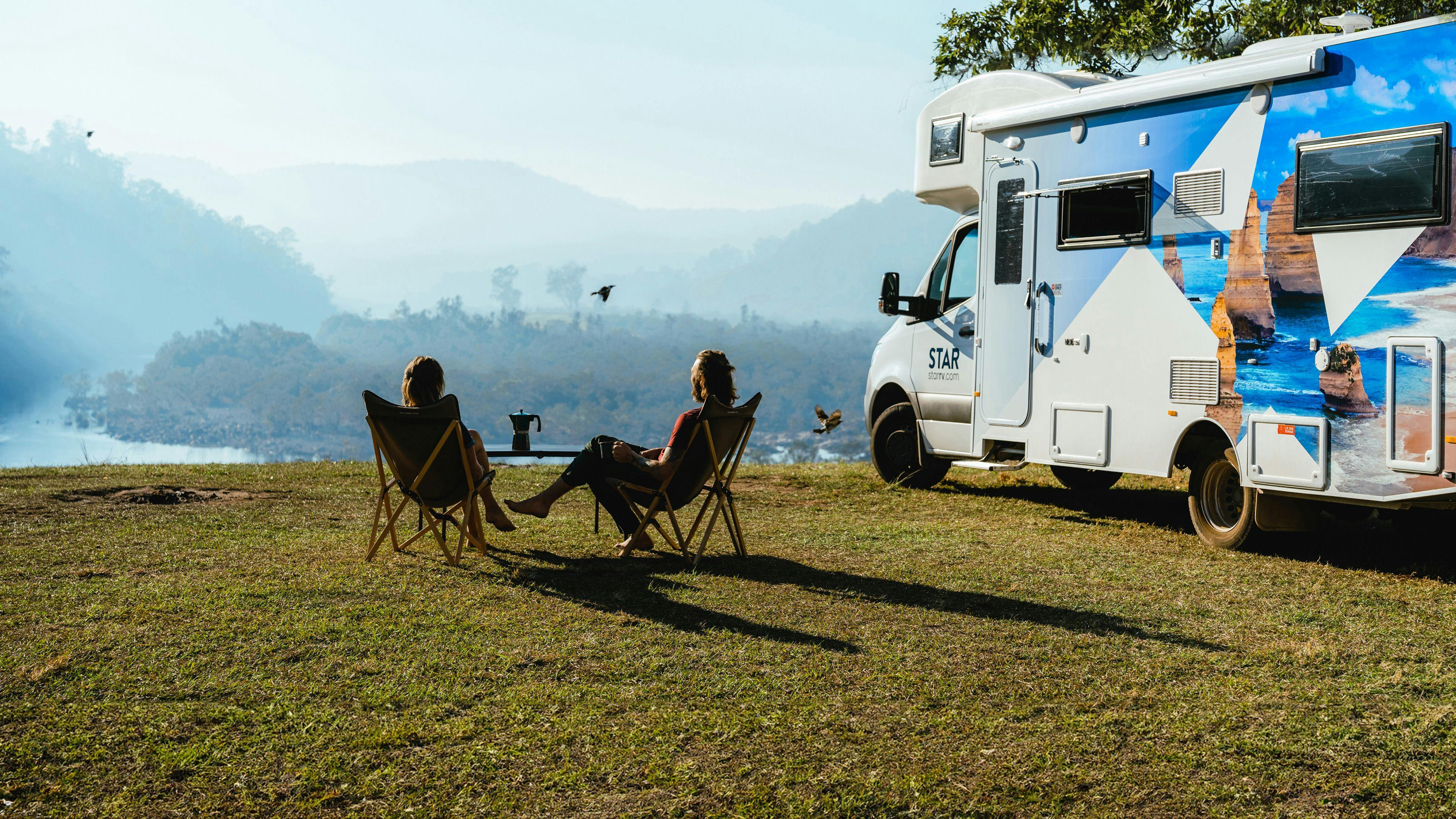 Couple relax in front of Star RV