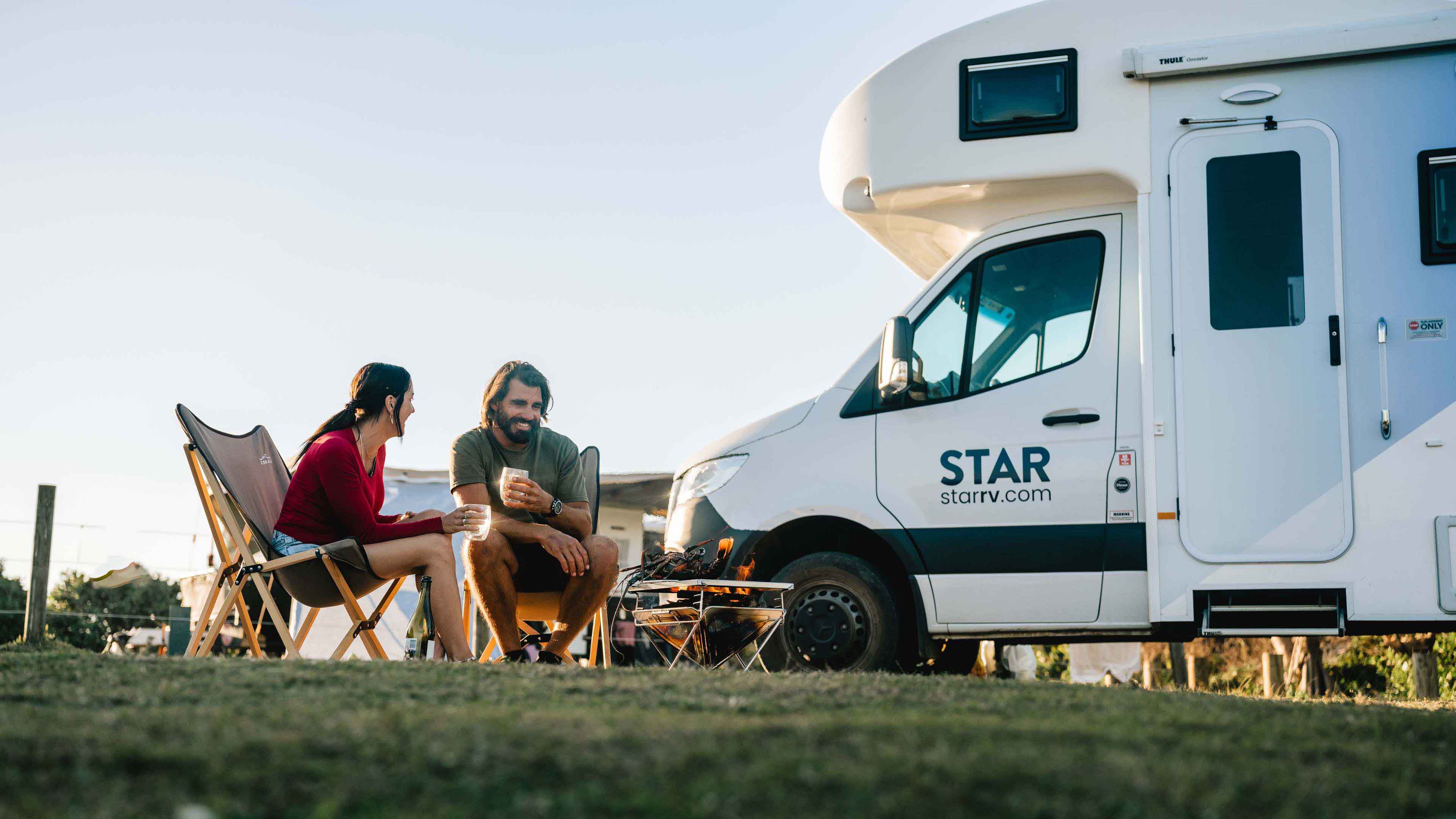 Couple sitting outside Star RV motorhome