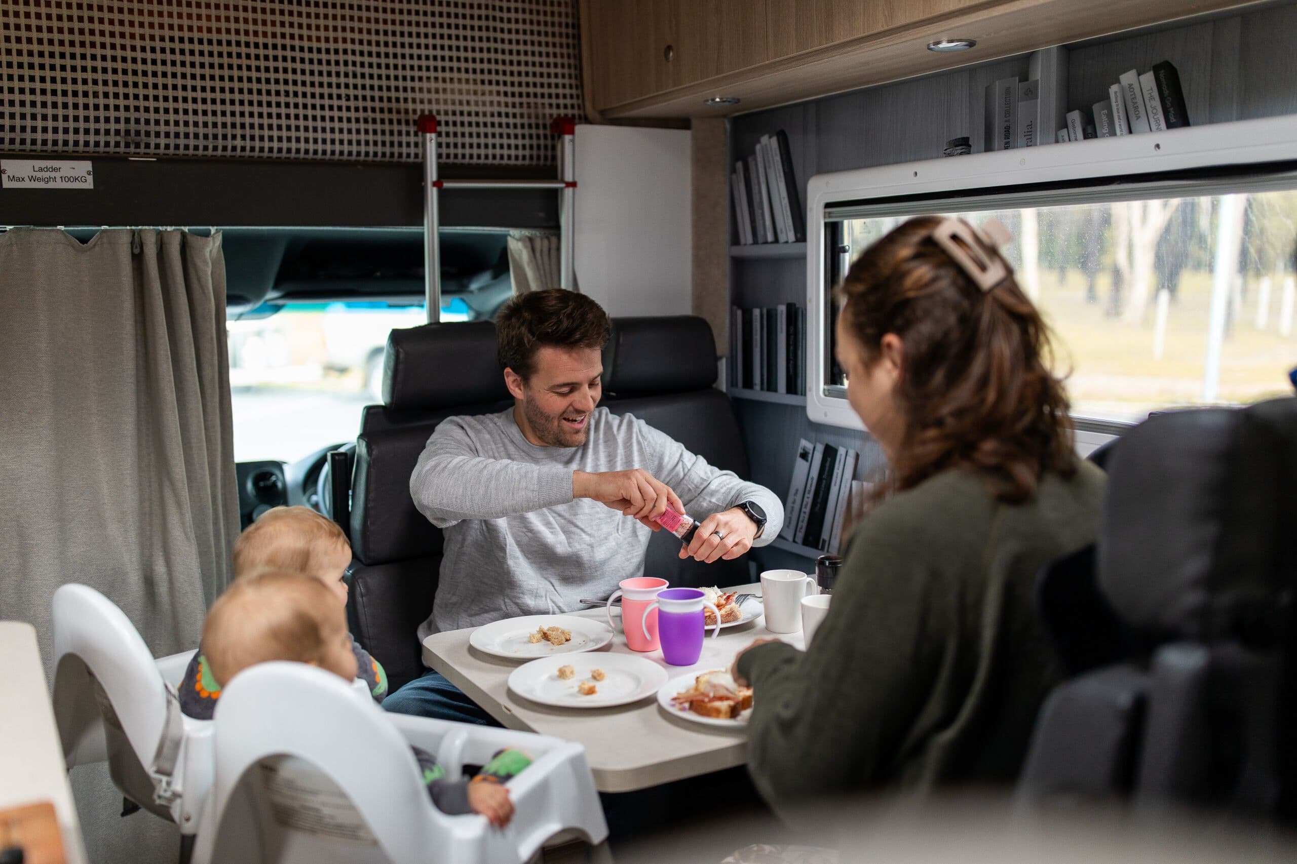 Family enjoying breakfast at the table inside a polaris 6 motorhome