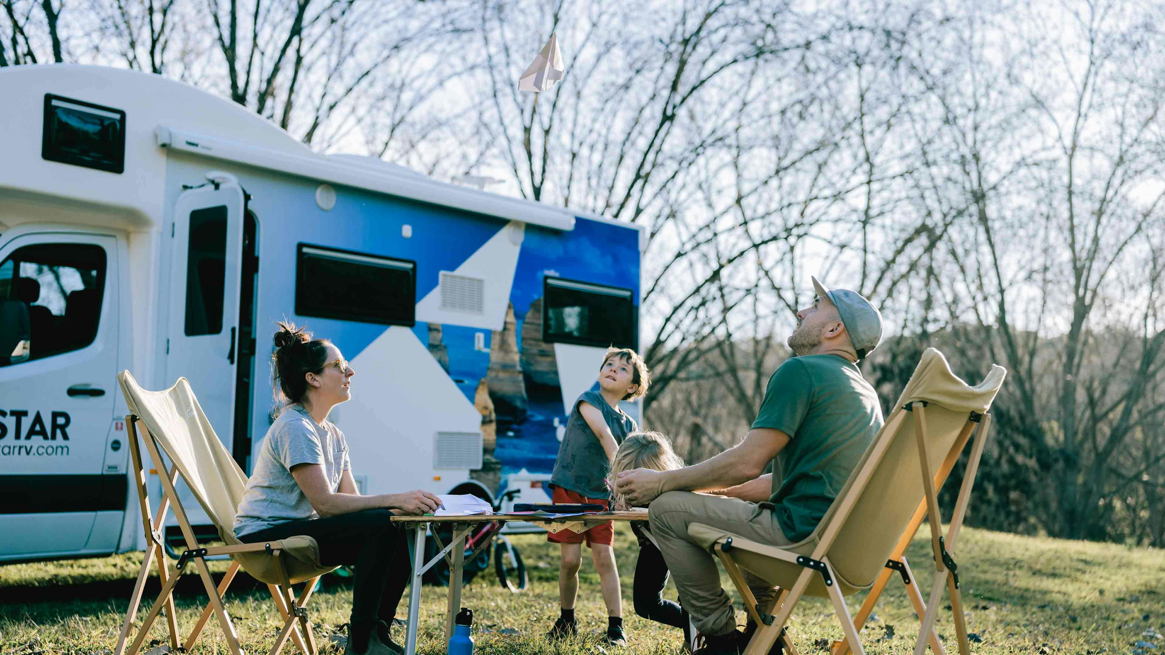 Family playing outside motorhome