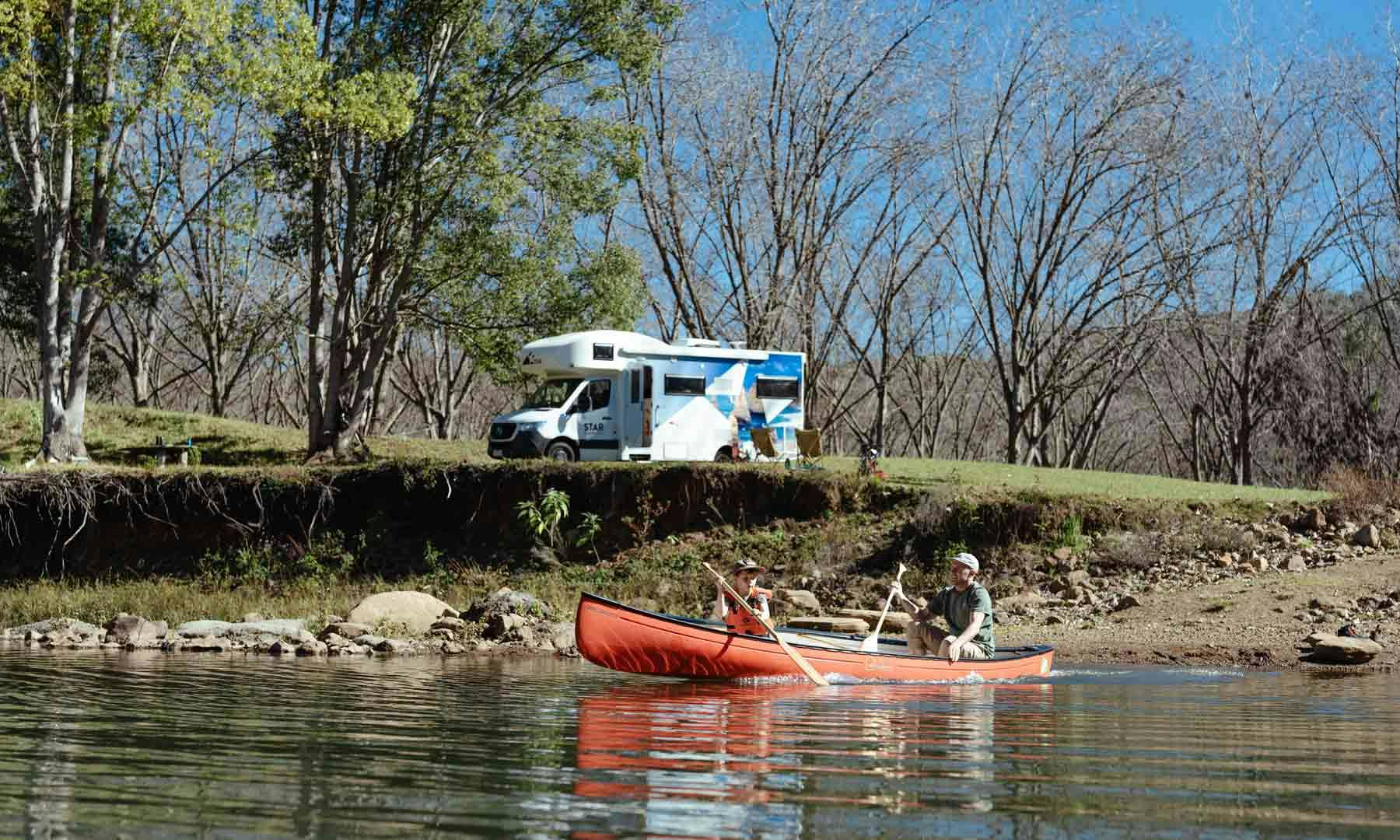 Father and son canoeing down river in Australia